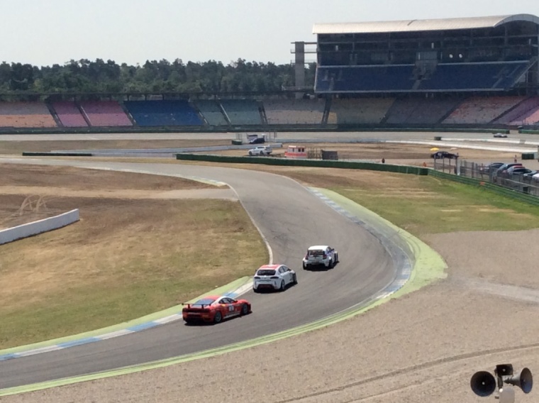 Three race cars on the circuit at Hockenheim Ring