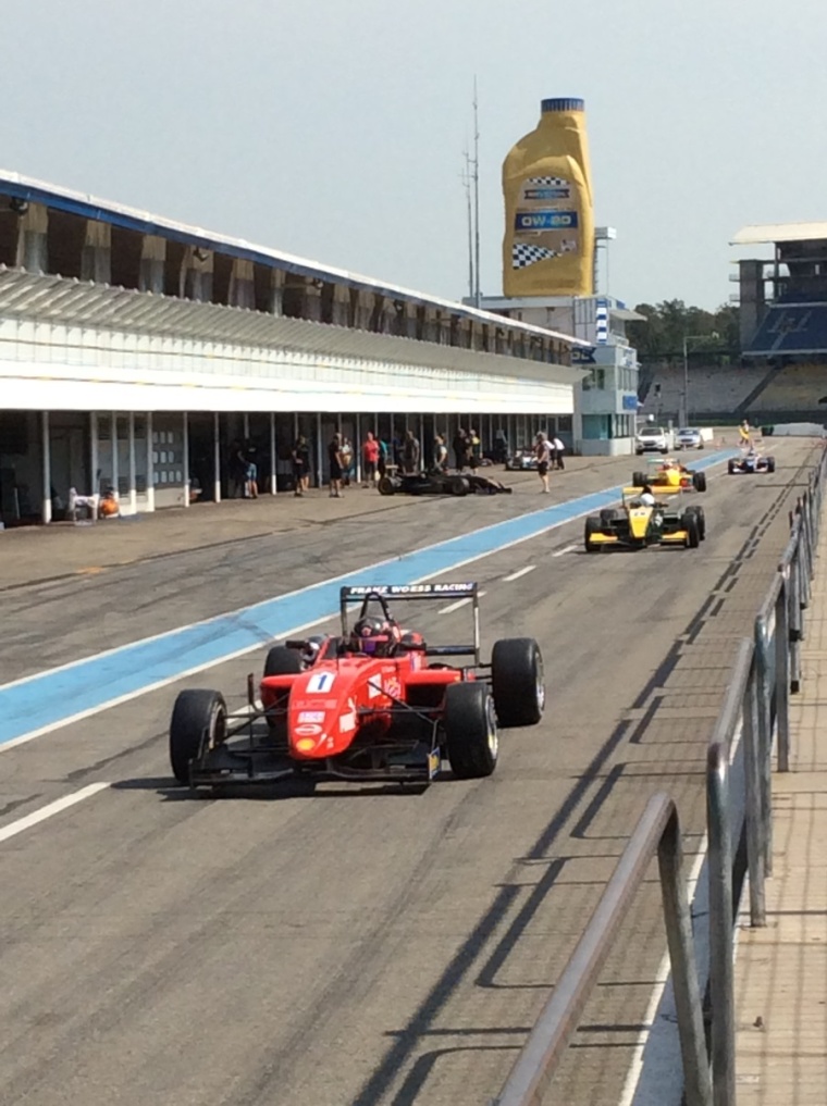 Some race cars leaving their boxes for the qualifying race