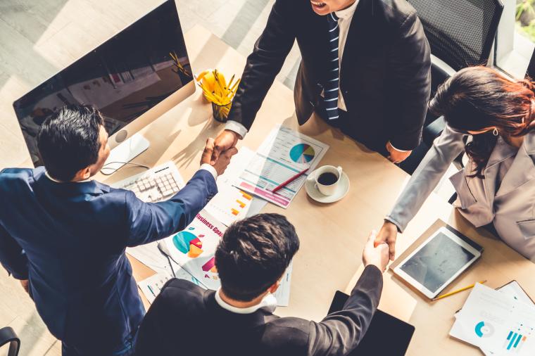 Group of business people handshake at meeting table