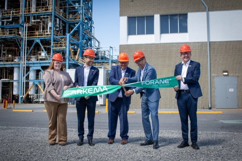 Company representatives at the ribbon cutting
